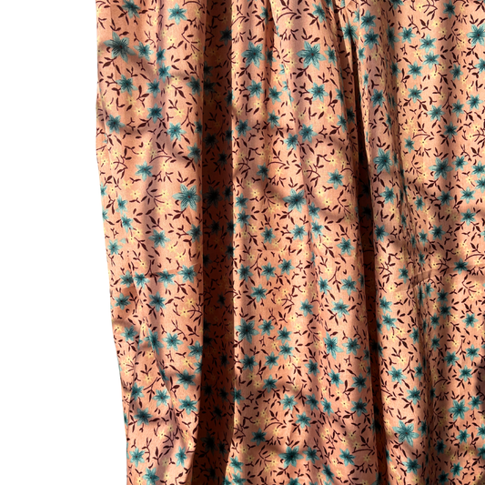 Floral patterned fabric with blue and brown flowers on a peach background